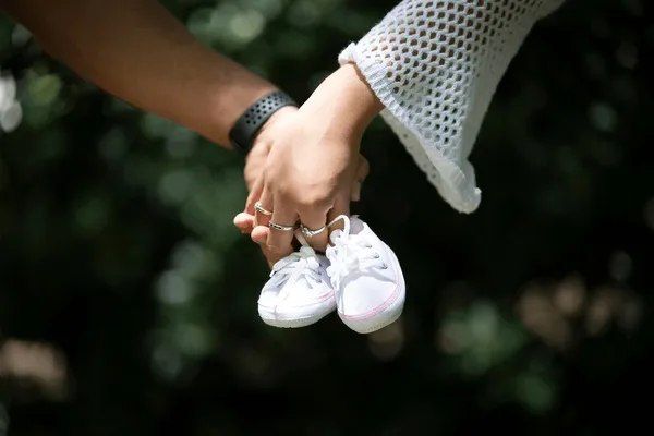 detail-couples-hands-holding-baby-600nw-2576423225